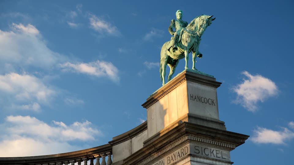 A statue of a man on horseback atop a pedestal with inscriptions.
