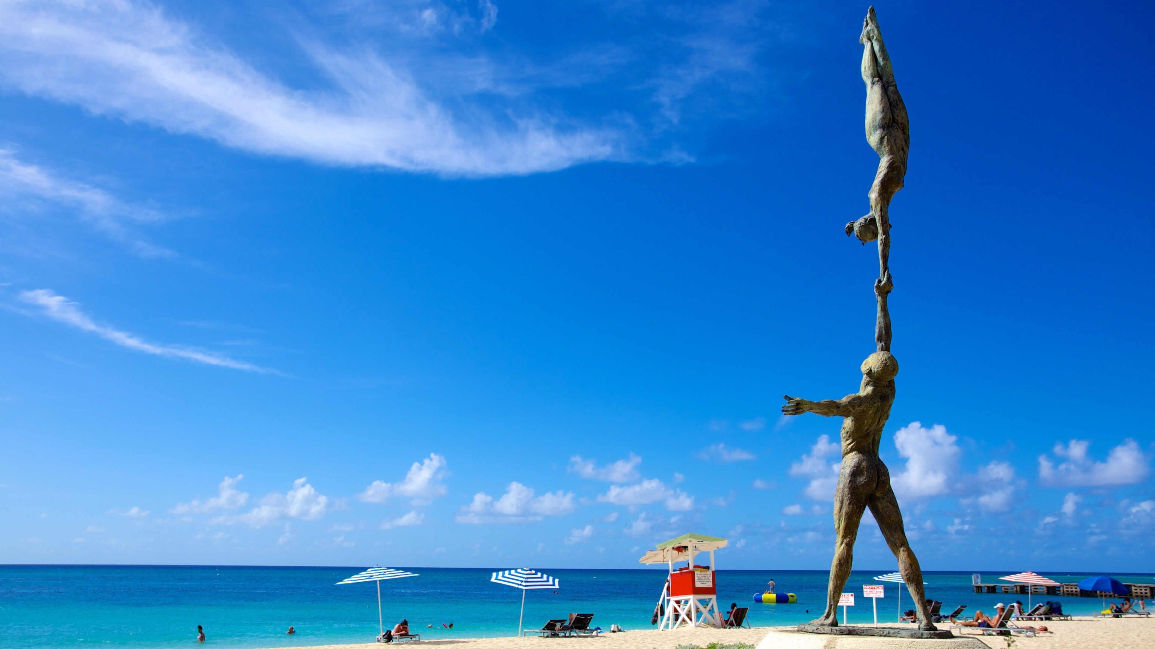 Doctor\'s Cave Beach featuring a sandy beach, outdoor art and a statue or sculpture