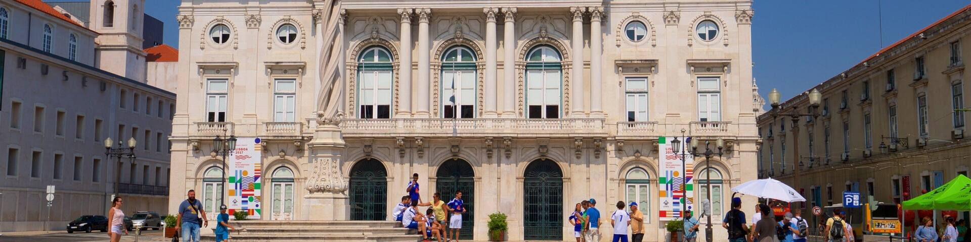 Lisbon District which includes a square or plaza and heritage architecture as well as a small group of people