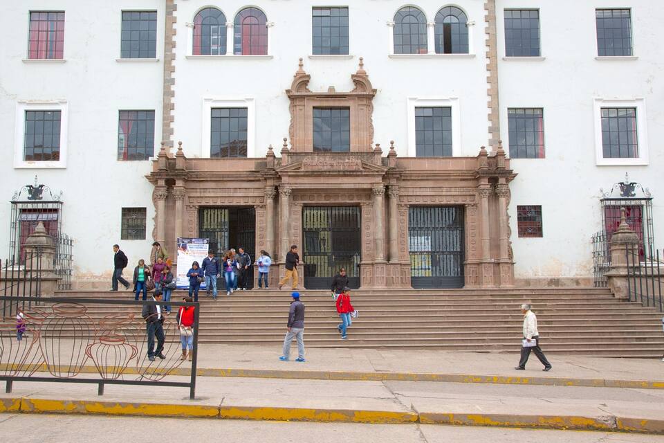 A historic building with a grand entrance and steps leading up to it.