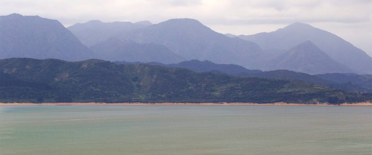 Omapere which includes tranquil scenes and a bay or harbor