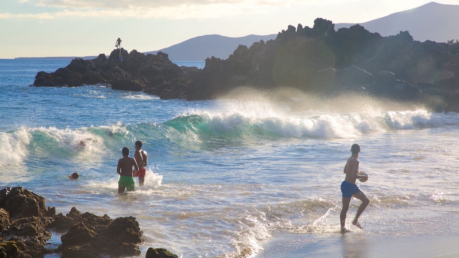 Playa Chica which includes general coastal views, a sunset and waves