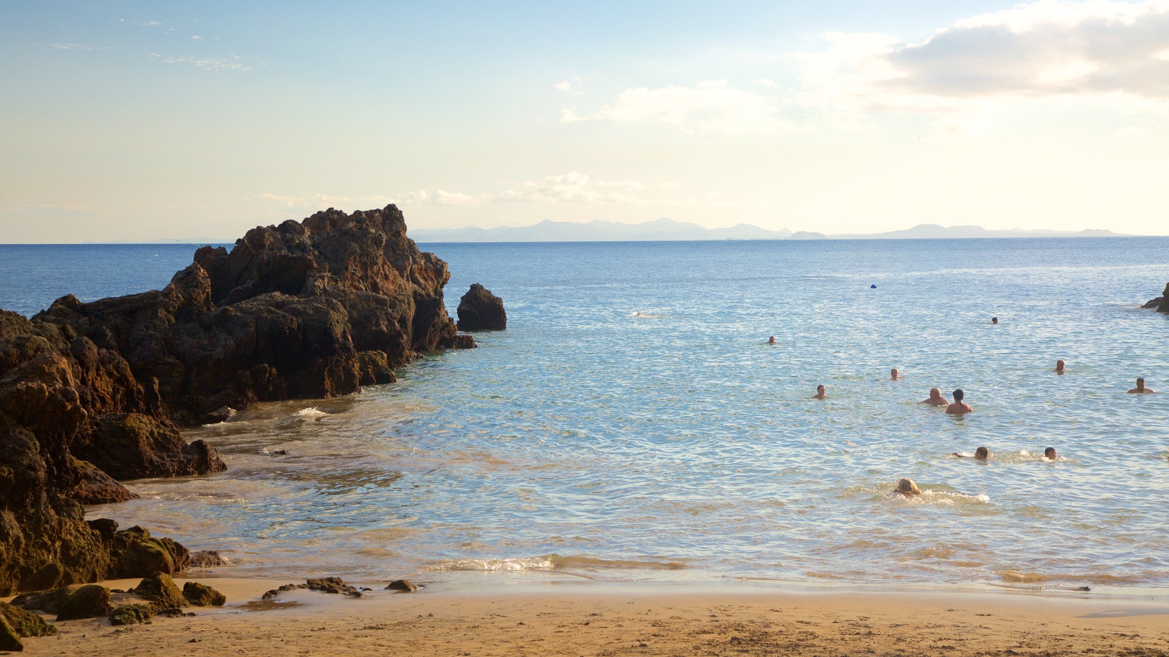 Puerto del Carmen showing a coastal town, swimming and general coastal views