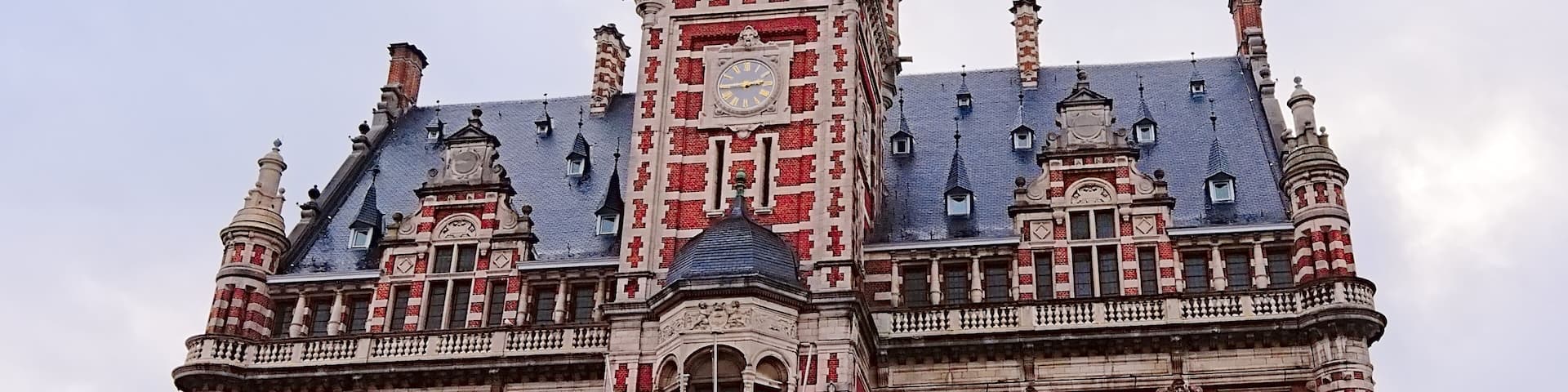 Old city hall of Borgerhout with clock tower in flemish neo renaissance style, Antwerp, Flanders, Belgium