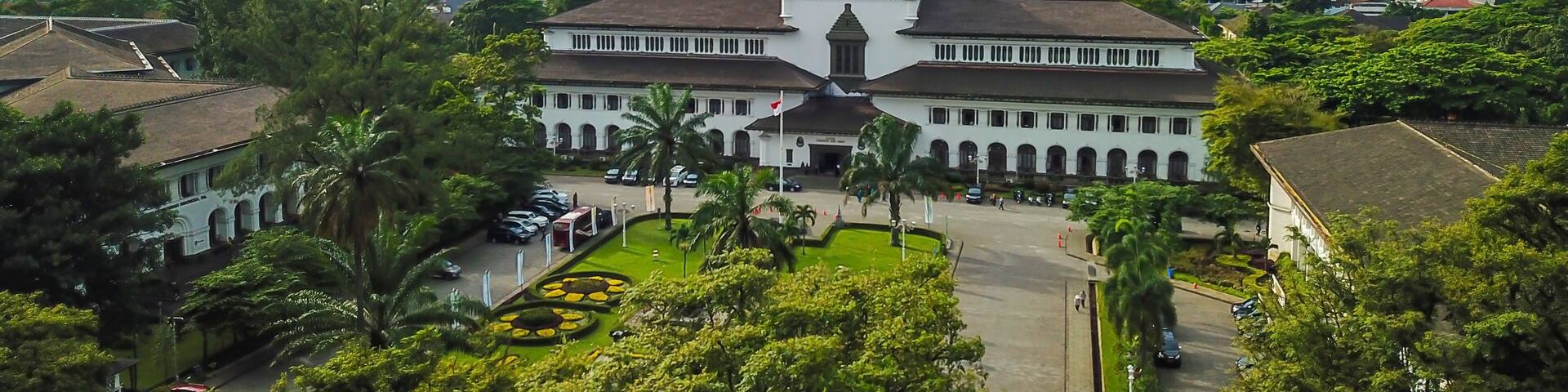 Aerial view of Gedung Sate, Bandung, West Java, Indonesia with beautiful sky and city landscape. Old Historical building with art decoration style, Governor Office, icon and landmark of Bandung city.