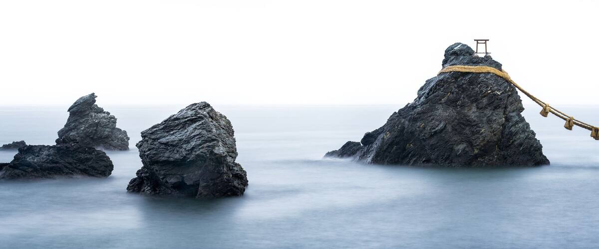 A series of rock formations with a rope bridge connecting them.