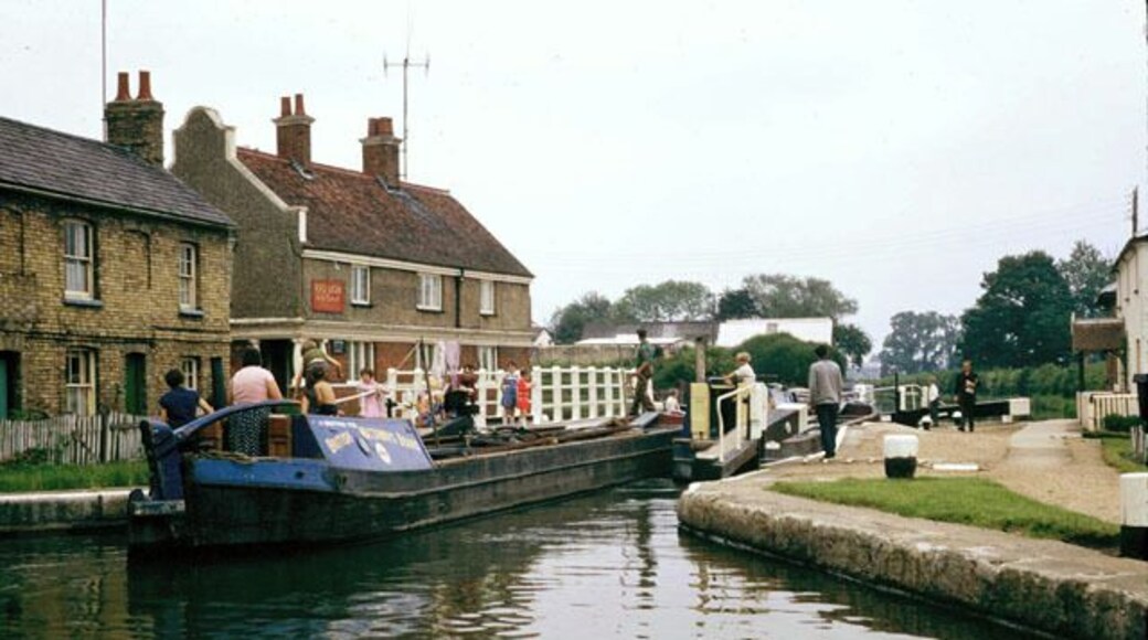 Fenny Stratford lock, 1968 The pub is the Red Lion. A pair of working boats are locking through. This lock has a swing bridge across its middle.