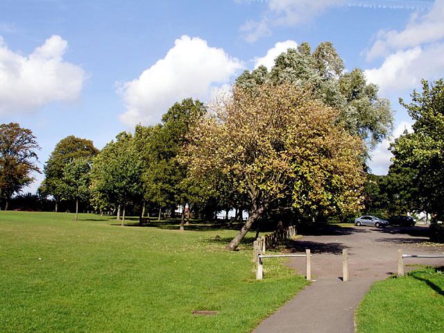 Ardagh Tennis Courts Car Park. The car park for the tennis courts and the access road leading upto Kellaway Avenue, lined by trees..