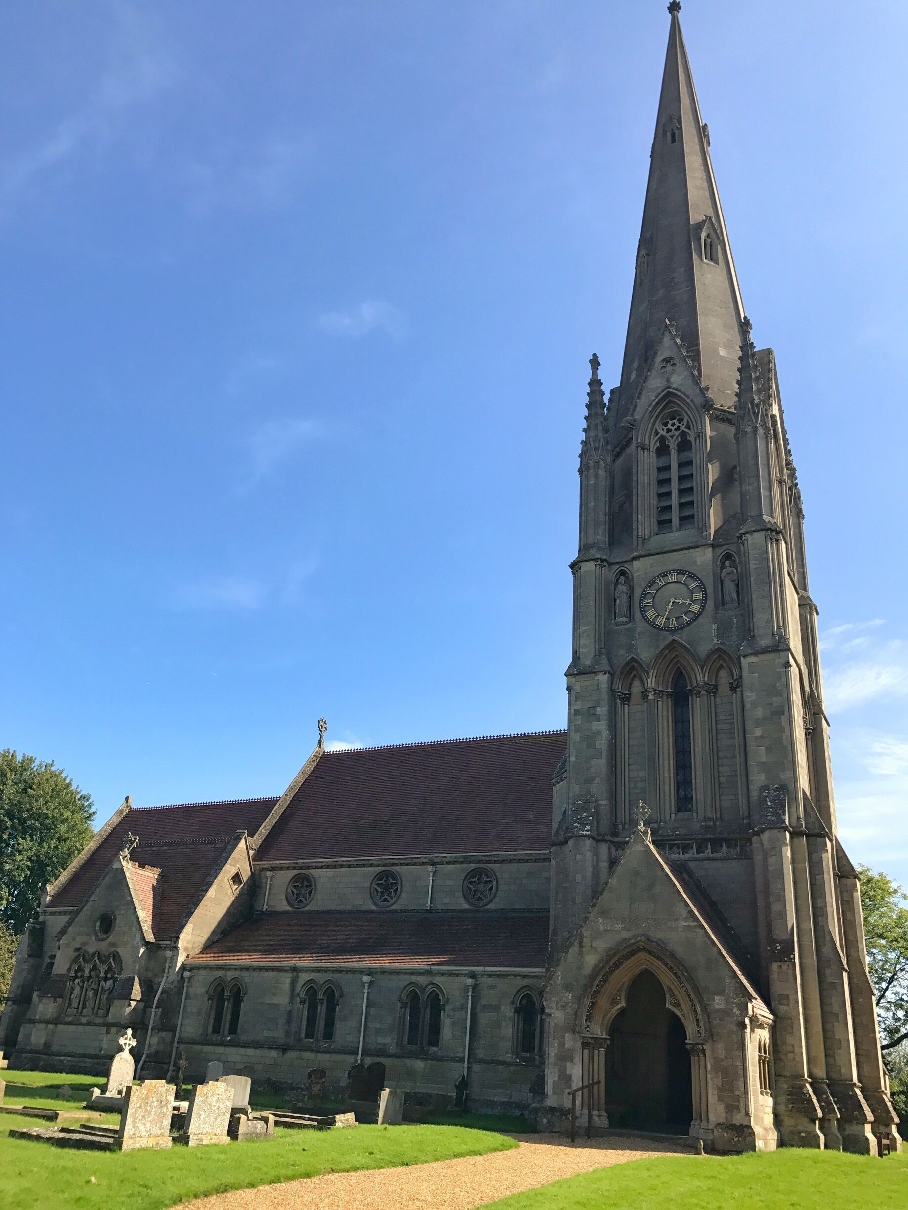 A historic church with a tall spire and a large clock tower.