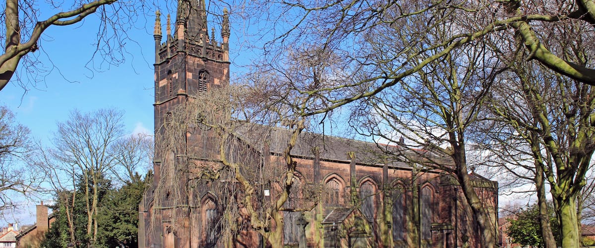 Grade II listed stone church in Knotty Ash, Liverpool, dating to 1835 with chancel and side chapel added 1890. in mixed, but compatible styles by Aldridge & Deacon.Seen from Brookside Avenue near junction with Thomas Lane.