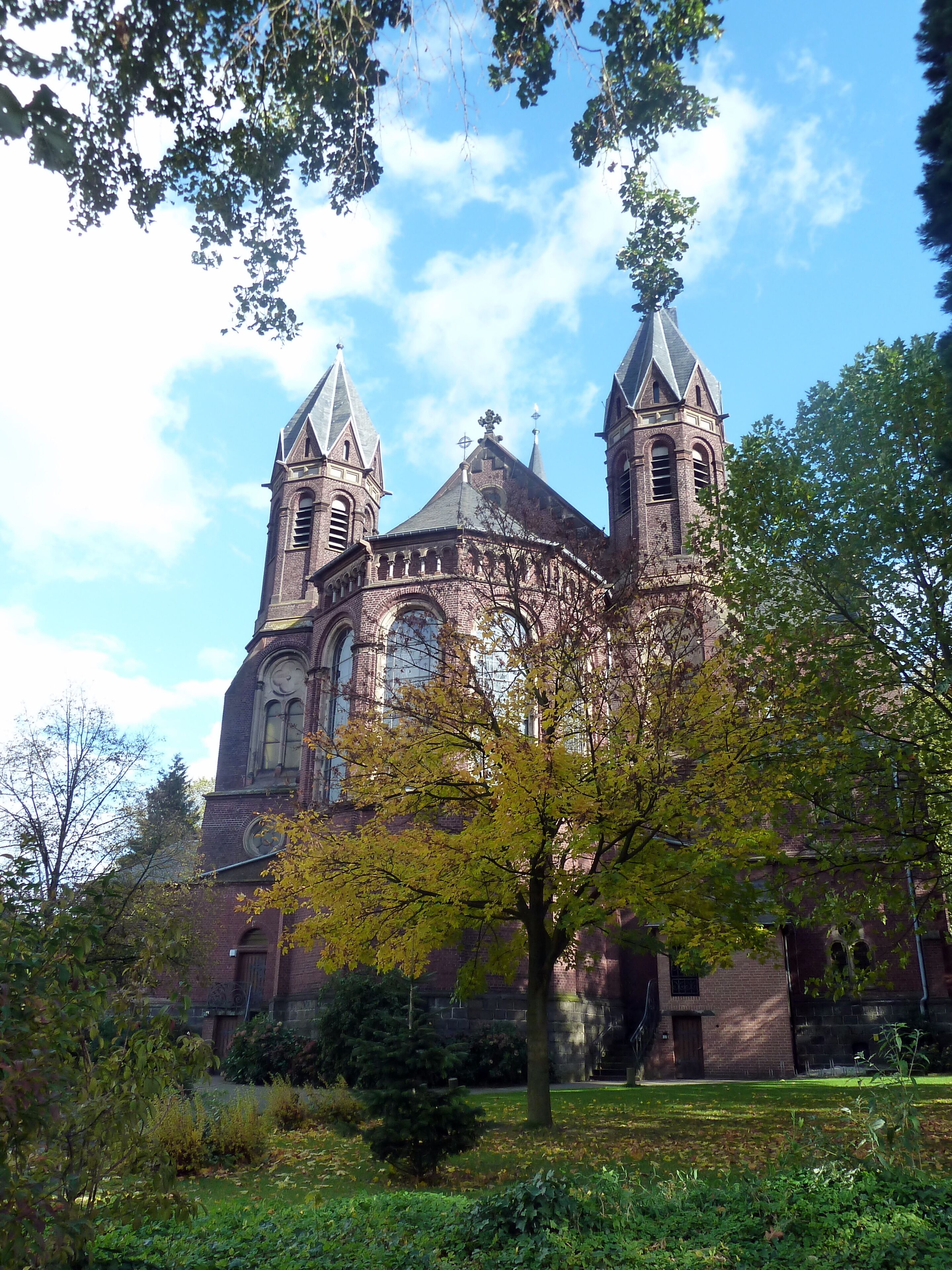 A historic church with two towers and a large arched window.