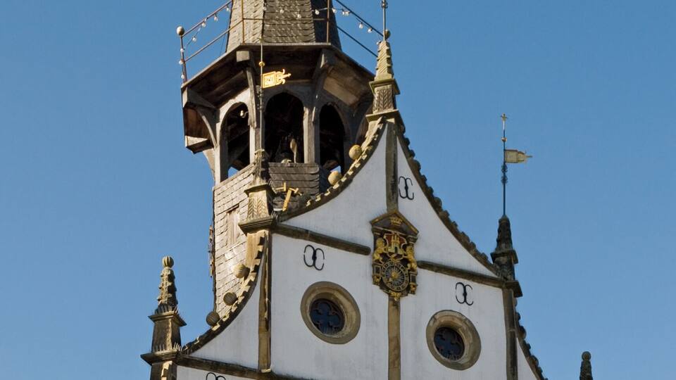 A church with a tall spire and a clock tower.