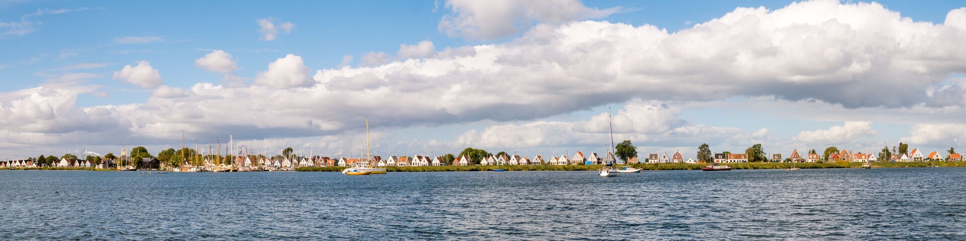 Skyline of dike village Durgerdam with old houses and boats, IJmeer, Amsterdam, Netherlands