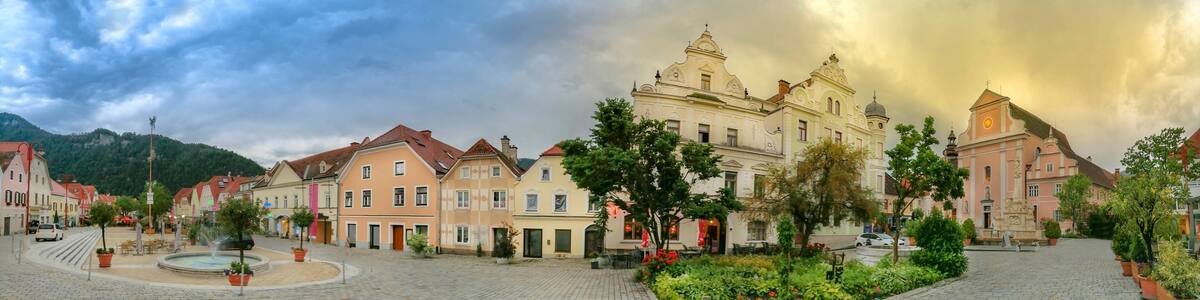 The main square with old buildings and Parish Church in the charming little town of Frohnleiten in the district of Graz-Umgebung, Styria region, Austria