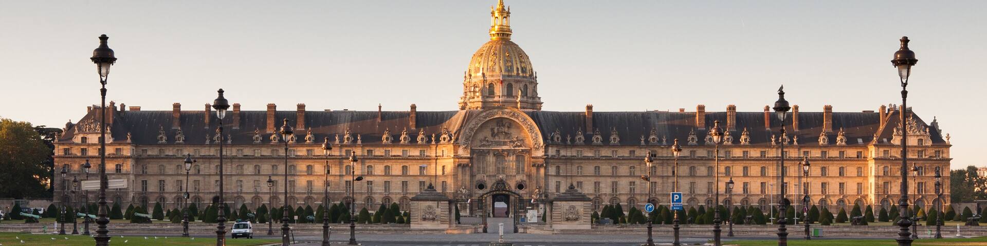 A grand historic building with a prominent dome and symmetrical architecture.