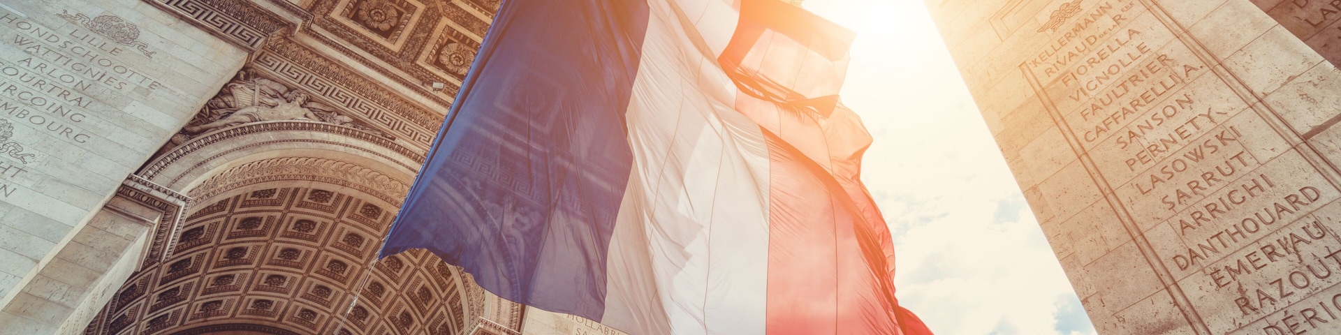 french flag at arc de triomphe during bastille day