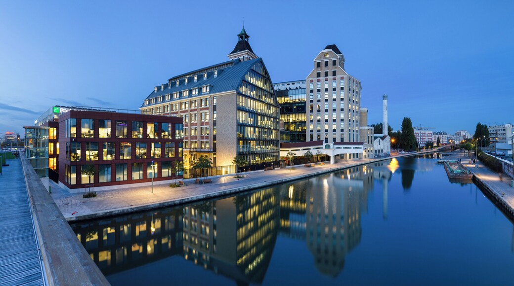 Pantin Mills, and canal of Ourcq, in Pantin, Seine-Saint-Denis, France. Renovated in the years 2000s, Pantin Mills now serve as offices and headquarters for BNP Paribas Securities Services. This picture is a mosaic of 13 pictures each taken at 21mm, f/8.0, 3.5 sec and ISO 100, with a Canon 7D + Canon 17-55 f/2.8 mounted on. Stitching itself was done with Hugin. Resulting horizontal FOV is 164°.