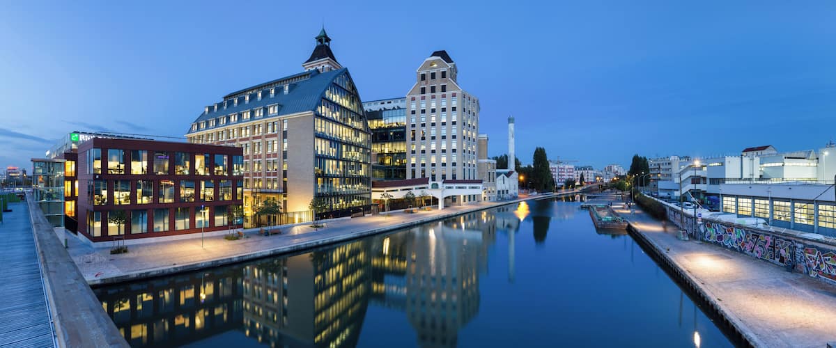 Pantin Mills, and canal of Ourcq, in Pantin, Seine-Saint-Denis, France. Renovated in the years 2000s, Pantin Mills now serve as offices and headquarters for BNP Paribas Securities Services. This picture is a mosaic of 13 pictures each taken at 21mm, f/8.0, 3.5 sec and ISO 100, with a Canon 7D + Canon 17-55 f/2.8 mounted on. Stitching itself was done with Hugin. Resulting horizontal FOV is 164°.
