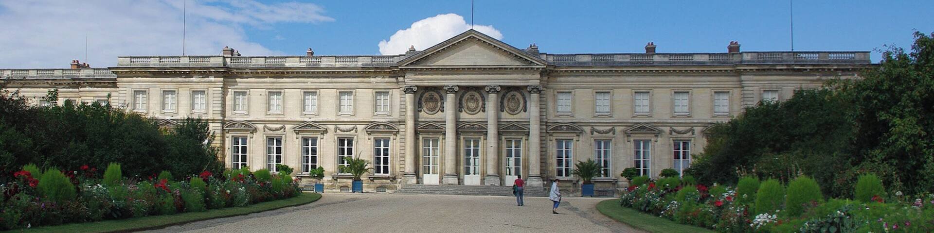 A large, classical building with a symmetrical facade, large windows, and a central entrance.