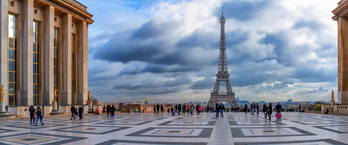Der Eiffelturm mit einem bewölkten Himmel im Hintergrund.