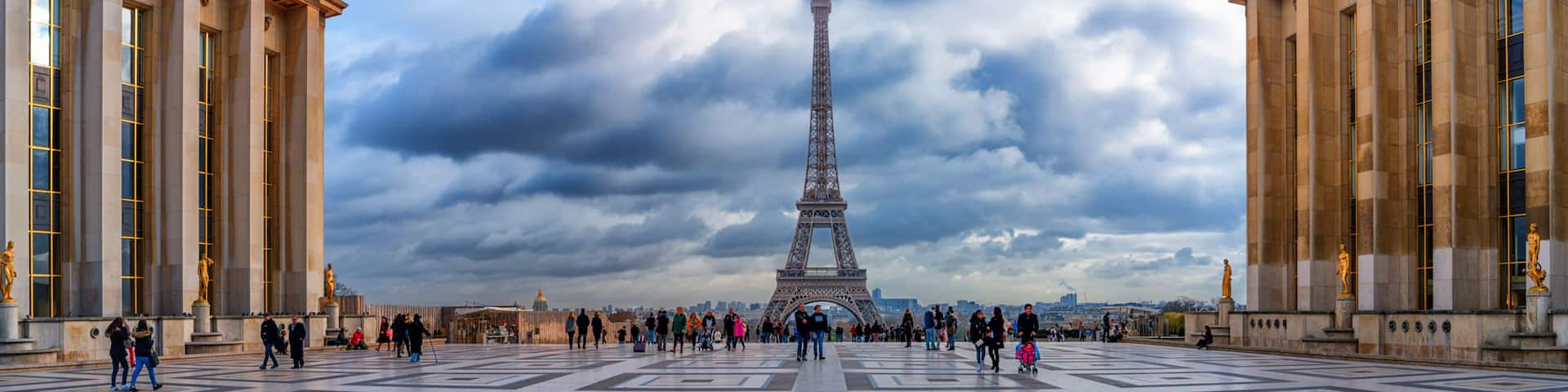 The Eiffel Tower with a cloudy sky in the background.