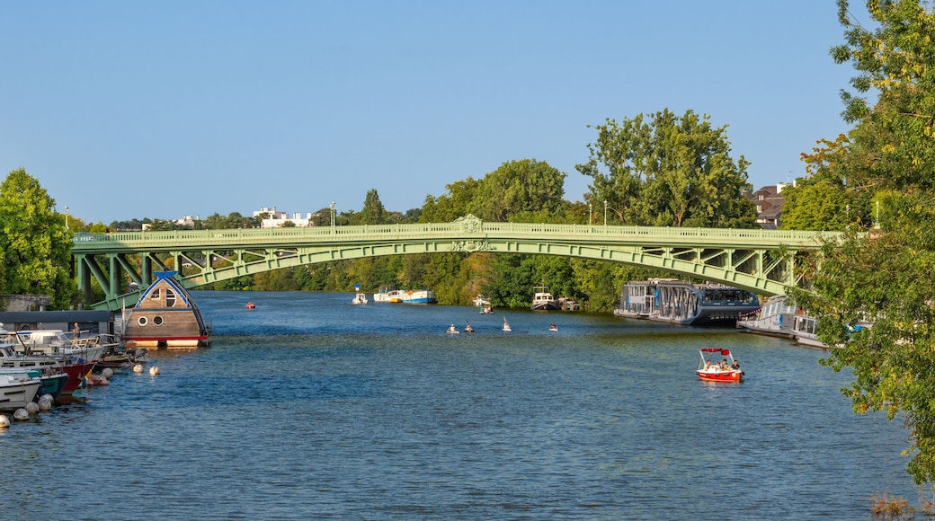 Scenic River View with Boats and Green Bridge