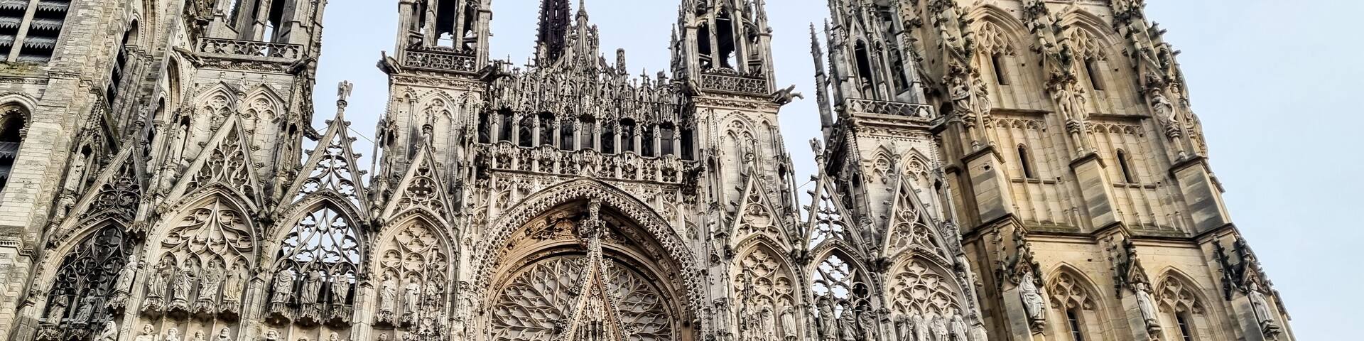 A Gothic cathedral with intricate stone carvings and multiple spires.