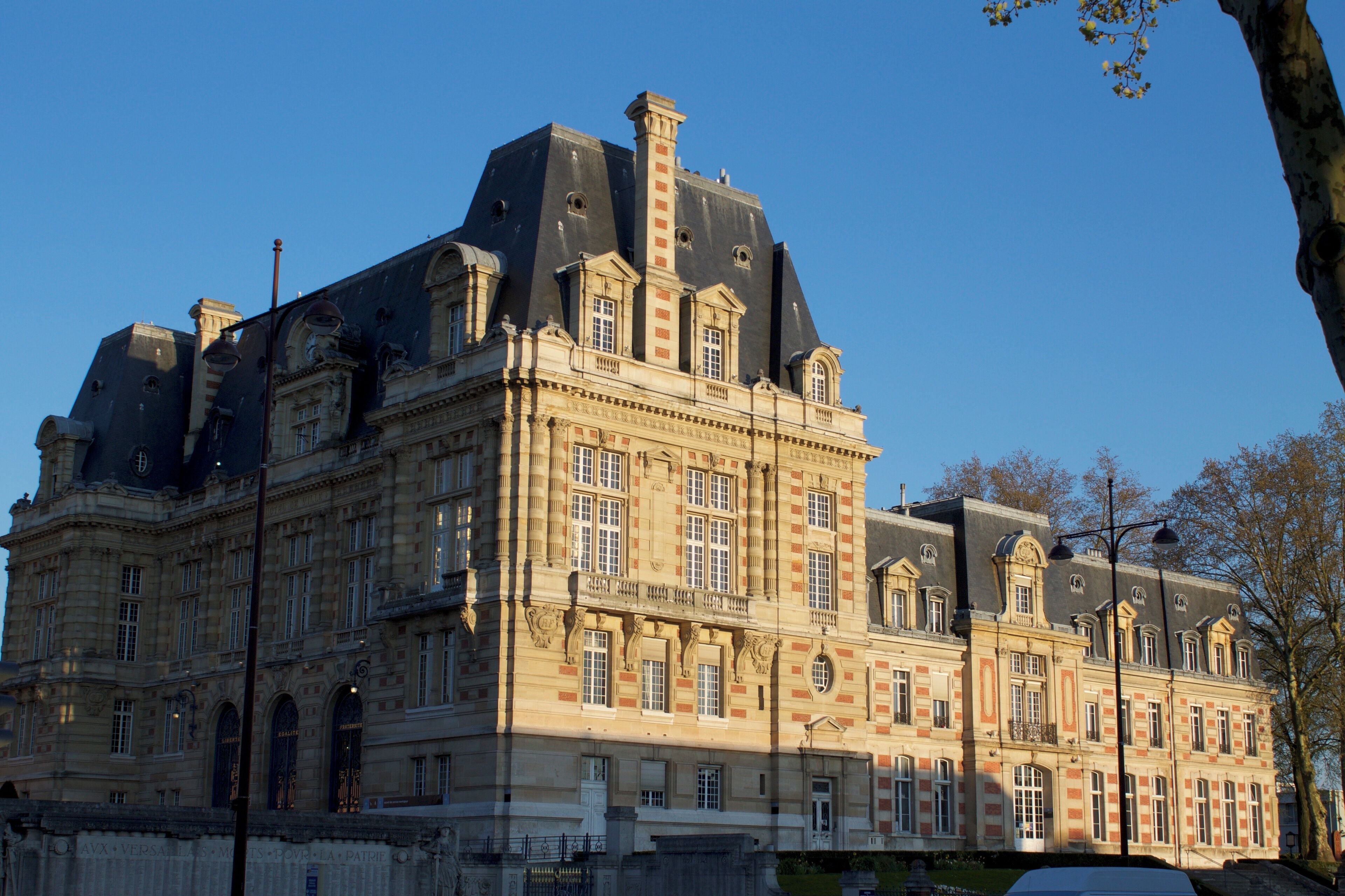 A large, historic building with multiple towers and arched windows.
