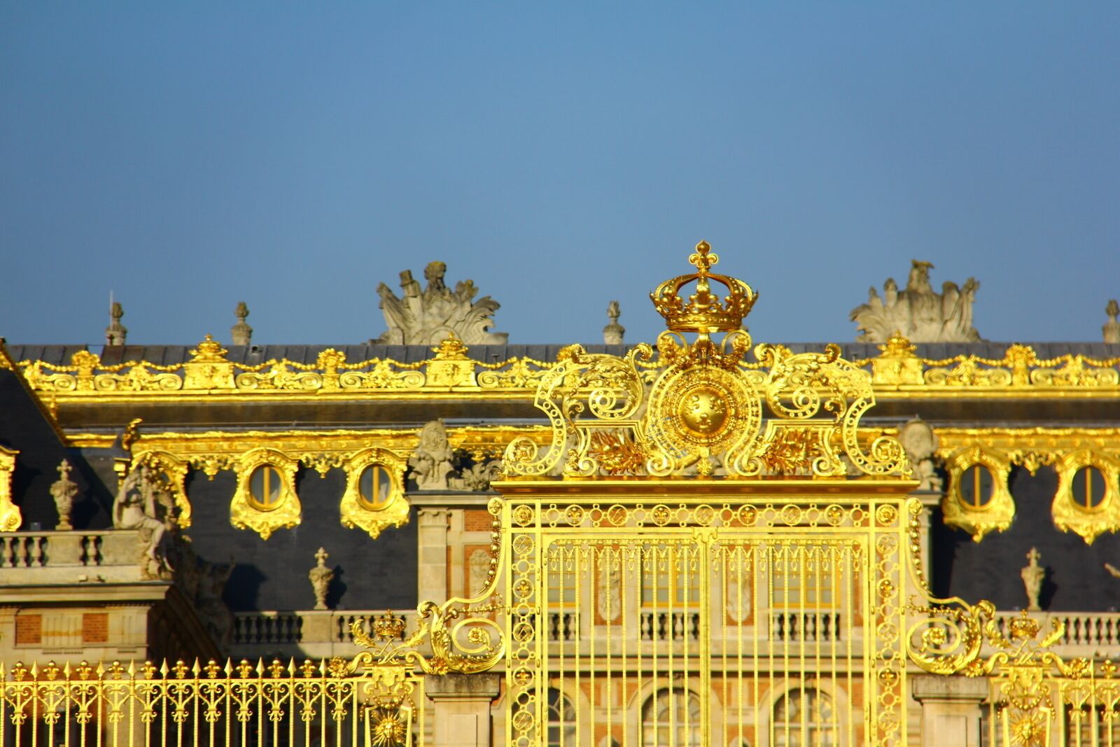 A grand, ornate building with intricate gold detailing and statues.