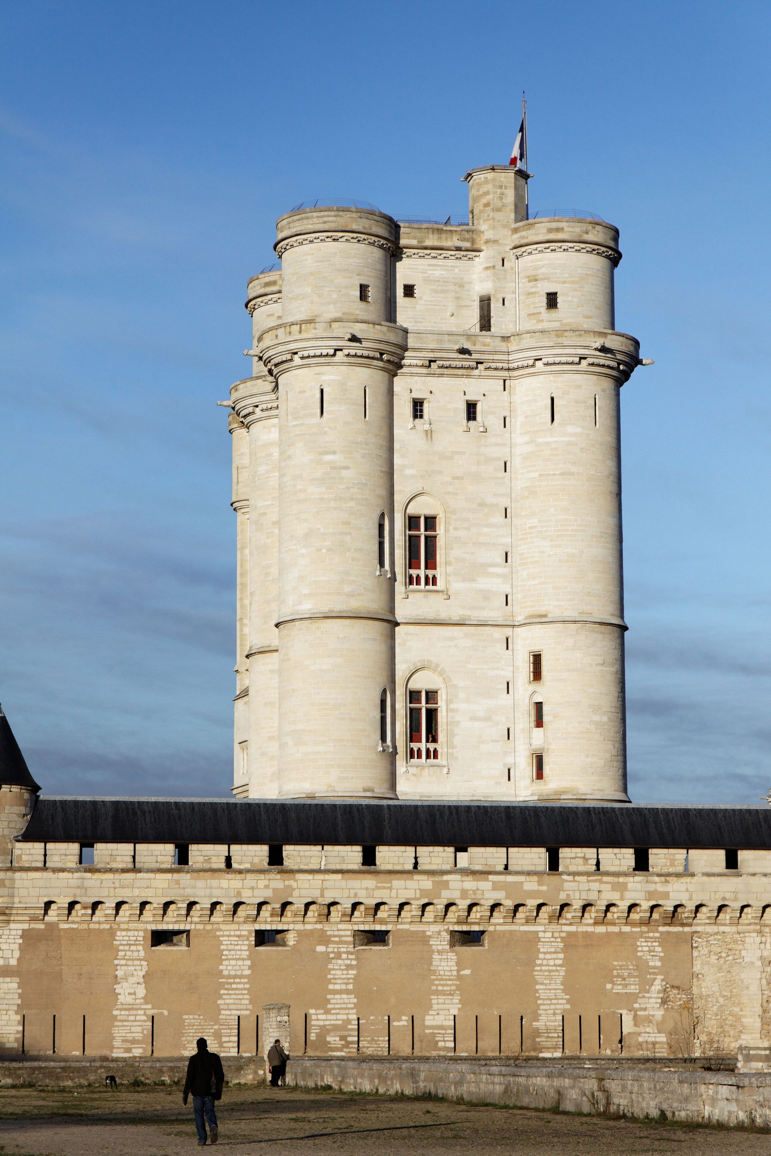 A large, historic tower with multiple levels and a flag on top.