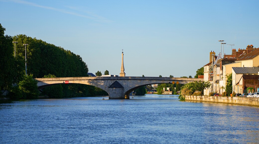The historic stone Louis XV bridge and a war memorial obelisk across the Oise river in Compiègne, Picardy, France
