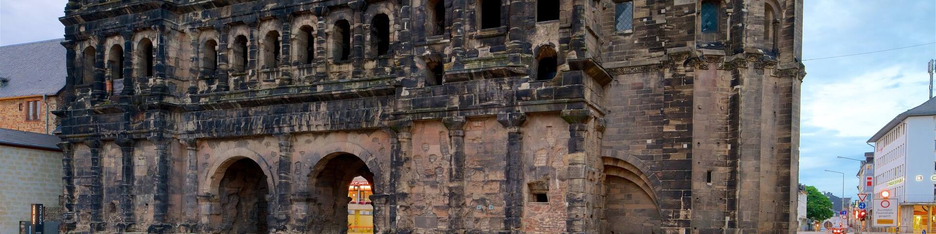 An ancient stone building with multiple arched windows and a large central archway.