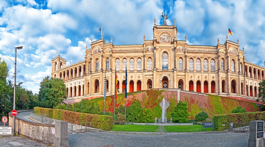 A historic building with classical architecture, featuring multiple arches and statues.