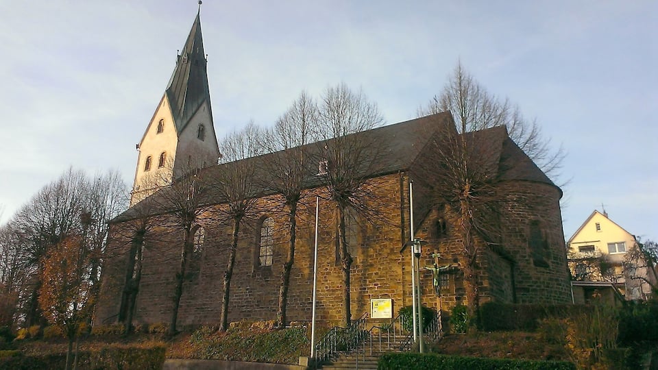 A historic church with a tall steeple and a brick facade.