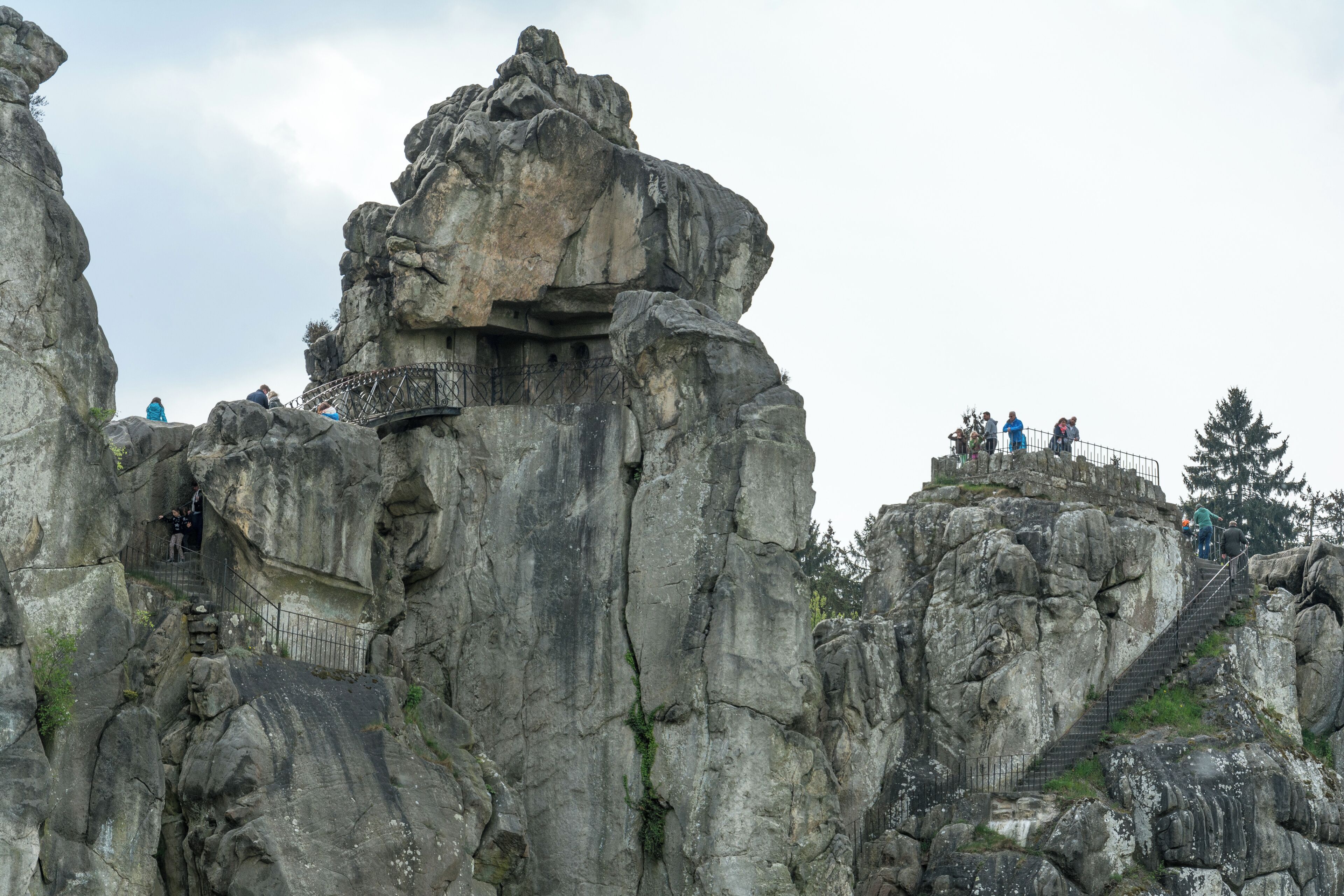 A rocky cliff with a metal staircase leading up to a viewing platform.