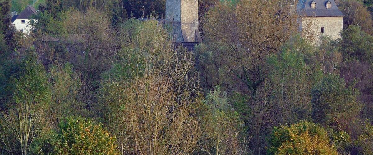 Wuppertal-Schöller: protestant parish church (centre), and defence tower of Gut Schöller (right); in background premises for limestone mining; October 2014