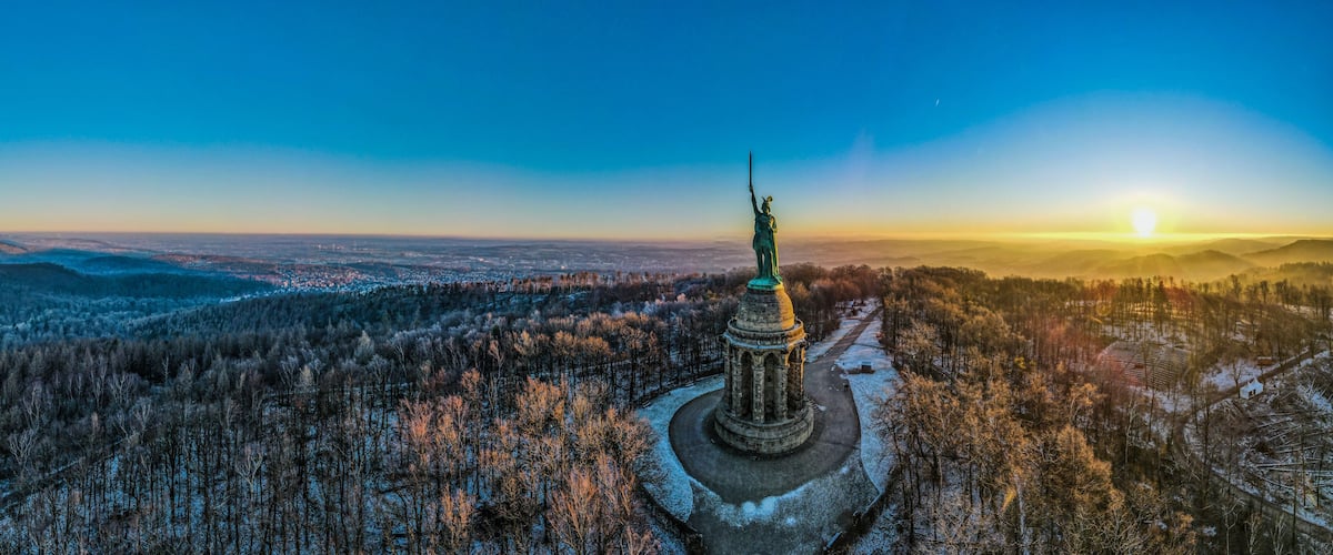 Una estatua en un paisaje nevado con cielo despejado.