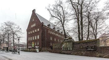 Town Hall and war memorial while snow falls, Dülmen, North Rhine-Westphalia, Germany