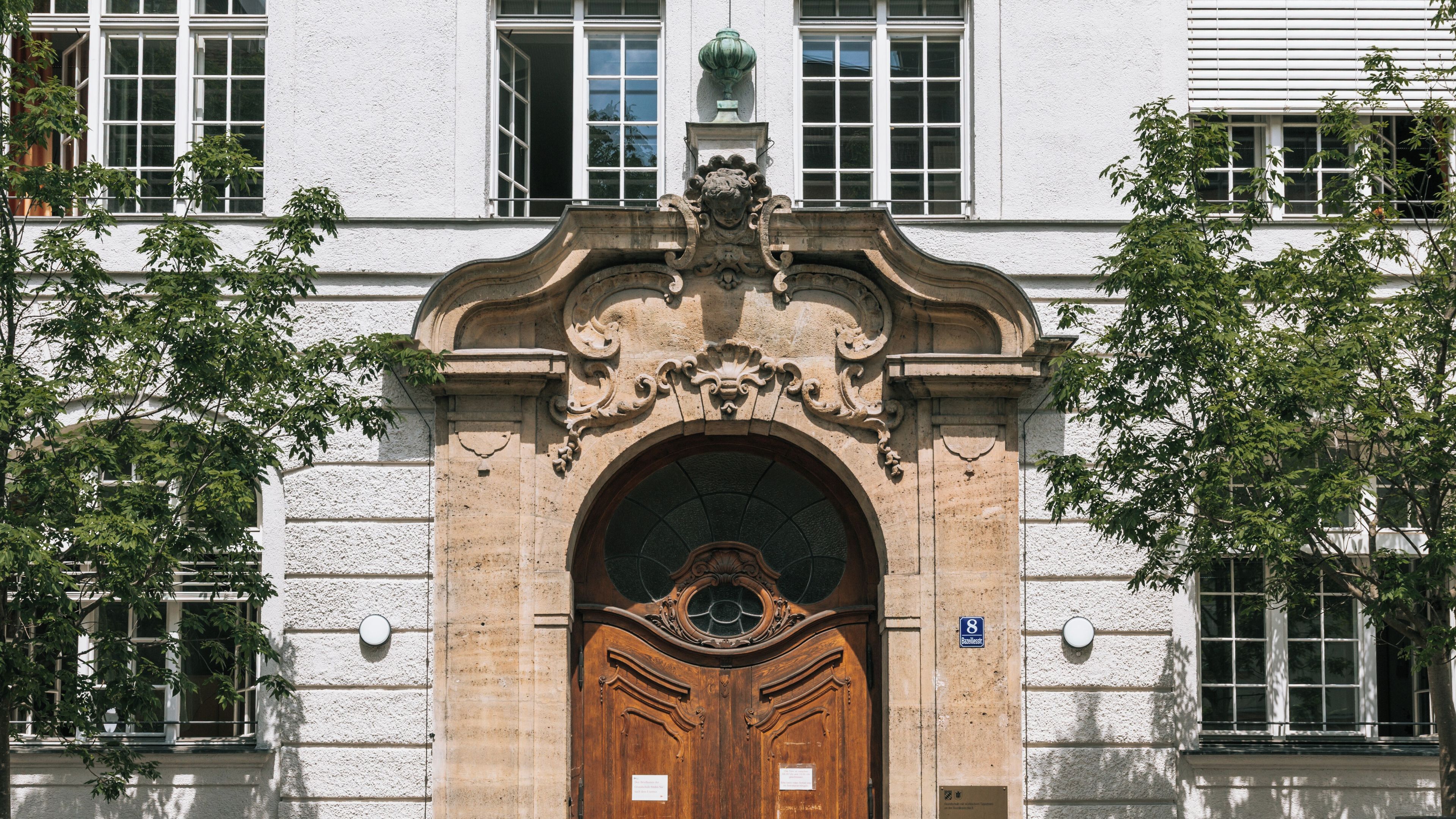 A historic building with ornate architectural details, including a large wooden door and decorative stonework.