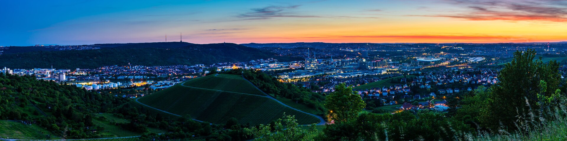 Germany, XXL panorama of downtown stuttgart city, houses and skyline from above in magic dawning atmosphere