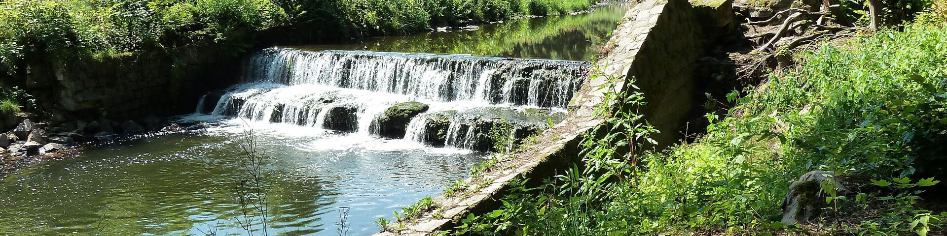 Picture shows the former inlet and an abandoned floodgate of the mill race from river Weisseritz to the nearby roller mill. The installation will be taken away in November 2017. After the floods of 2002 and 2013 the river bank gets hard-armoured with large rocks for preventing erosion when the river becomes a torrent and for maintaining the flood conveyance capability in the V-shaped valley. When further existing, the inlet would spoil the coherence of the river bank.