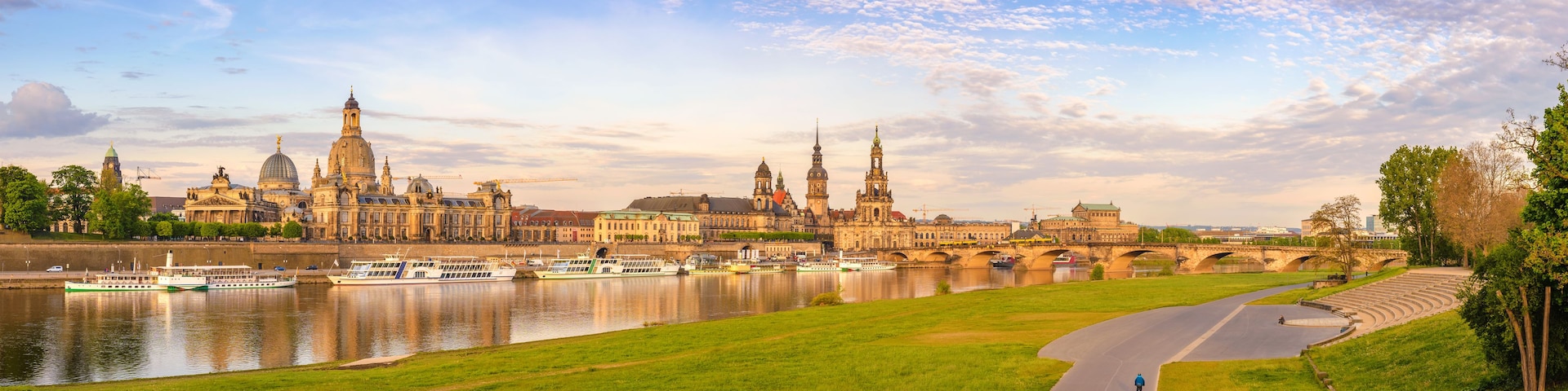 A river with boats, a bridge, and historic buildings.