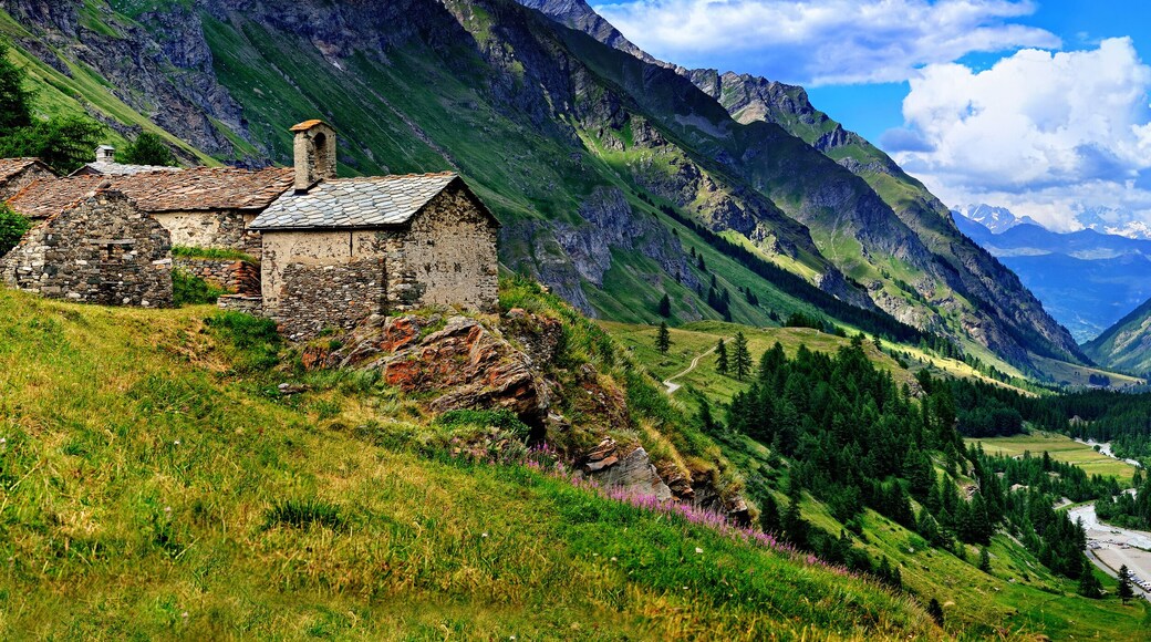 The old architecture with mountains on the panoramic view in Aosta