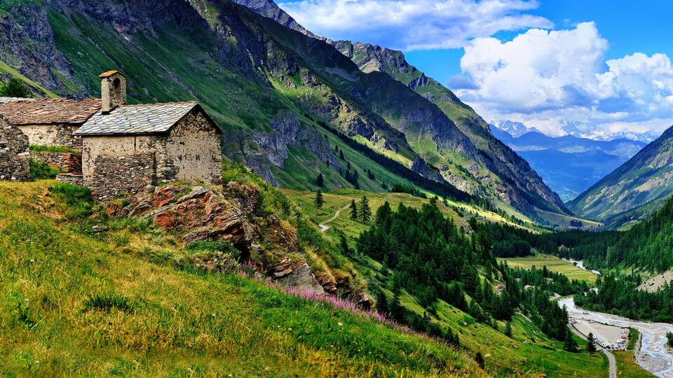 The old architecture with mountains on the panoramic view in Aosta