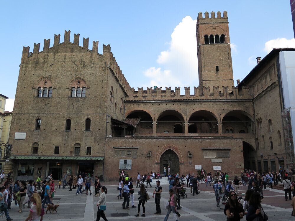 Un edificio histórico con una torre y ventanas de arco.