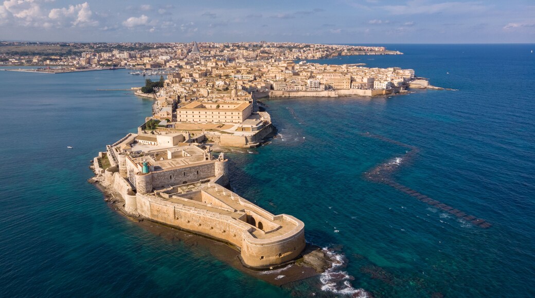 Aerial view of Ortigia, historical centre of the city of Syracuse. Aerial view of Maniace fortress in Ortigia, Sicily, Italy. Sanctuary "Our Lady of Tears" is at the background