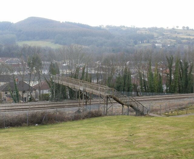 Railway footbridge, Pontymister Viewed from Herbert Avenue. The footbridge crosses the Cardiff to Ebbw Vale railway line less than a kilometre east of Risca and Pontymister station. On the far side of the bridge, a path leads to Ty-Isaf Park Road.