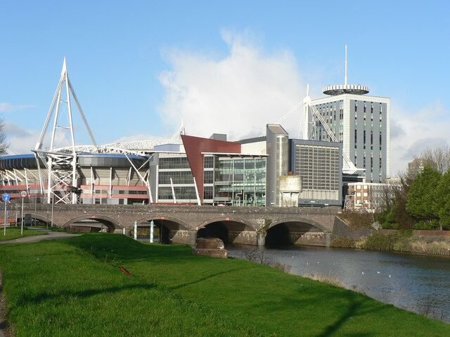 Bridge over the River Taff - Cardiff Behind the railway bridge is a road bridge linking Tudor and Wood Streets. Just in front of the bridge, to the left, are striped poles at the water taxi stop with, just visible in the background, the Millennium Stadium and associated buildings!
