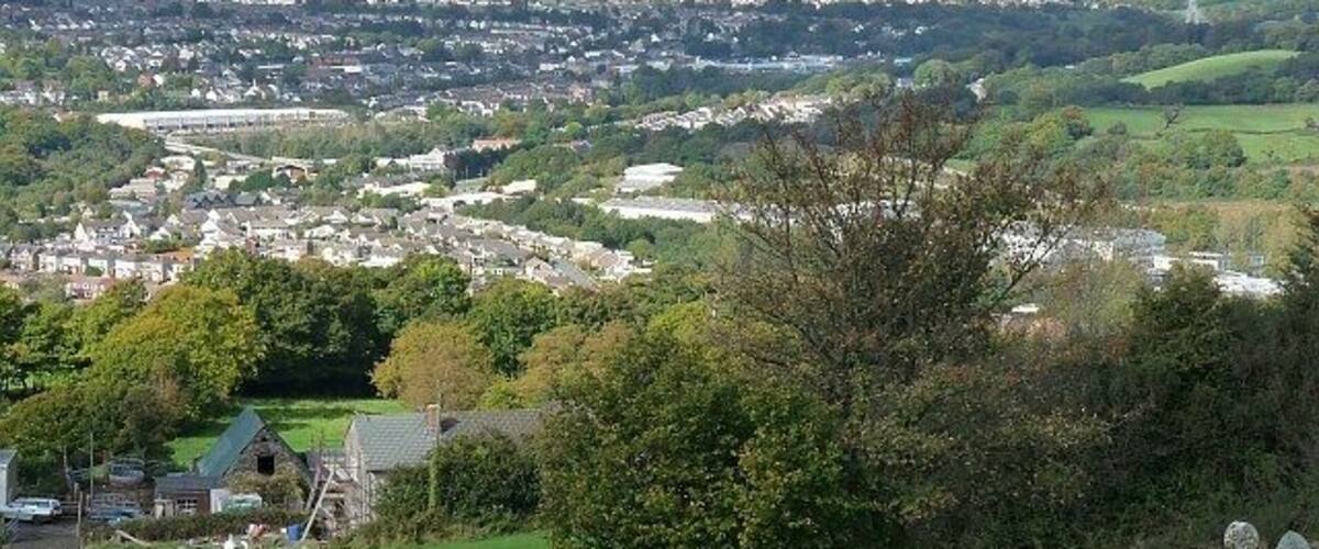 View over the Sirhowy Valley. Taken from the churchyard of New Bethel Church, Mynyddislwyn 1570832. Overlooking Ty-Fry Farm, Cwmnantyrodyn, Pontllanfraith and Blackwood with the tower of Chartist Bridge https://www.geograph.org.uk/photo/764929 visible at the upper right. On the horizon are the peaks of the Brecon Beacons https://www.geograph.org.uk/photo/18832 .