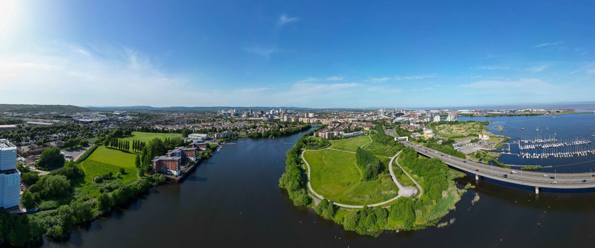 180° Aerial Drone Panorama Over Cardiff Bay, River Ely, Hamadryad Park, Cardiff Bay Wetlands Reserve, Cardiff Bay Link Road, and the City Skyline on a Clear Summer Day, Wales, United Kingdom - 1/2